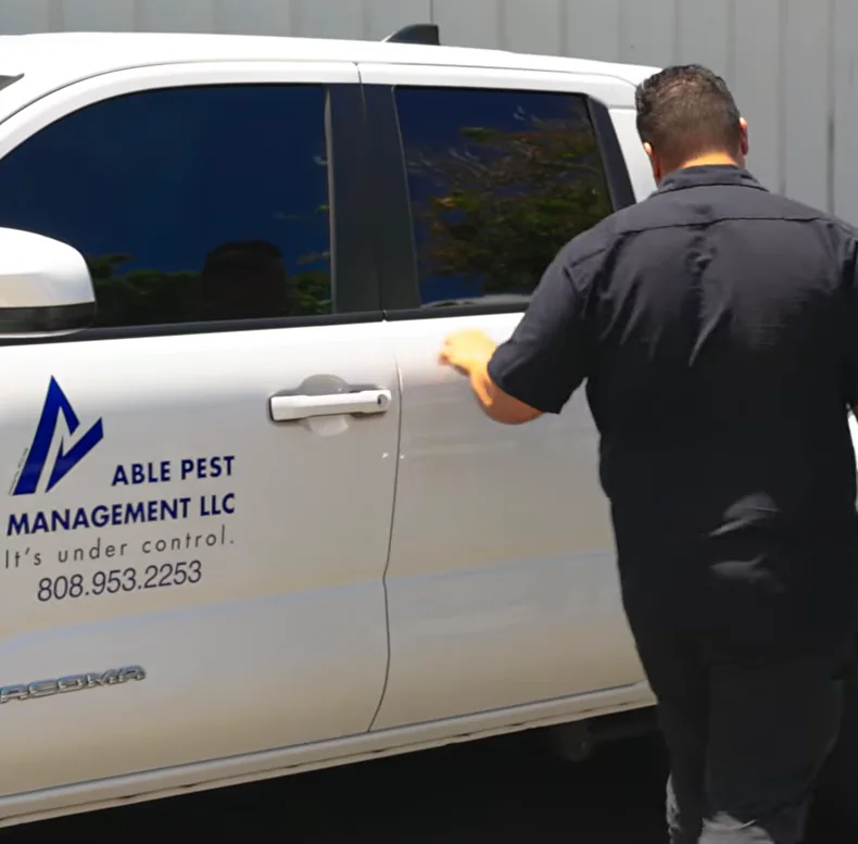 An Able Pest Management technician at the company truck