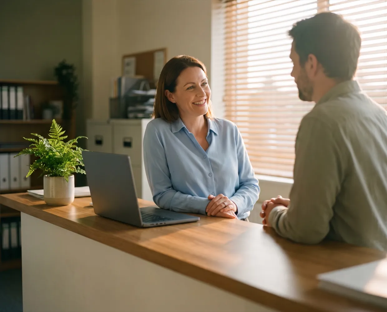 An office manager talking with a colleague at the front counter